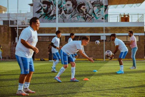 How can football academies in the UK better prepare young athletes for professional trials?